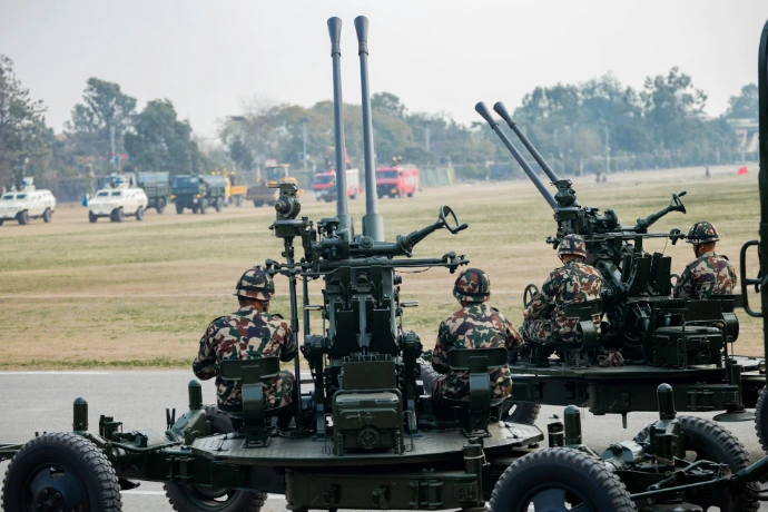 Soldiers operate anti-aircraft guns in a military parade.